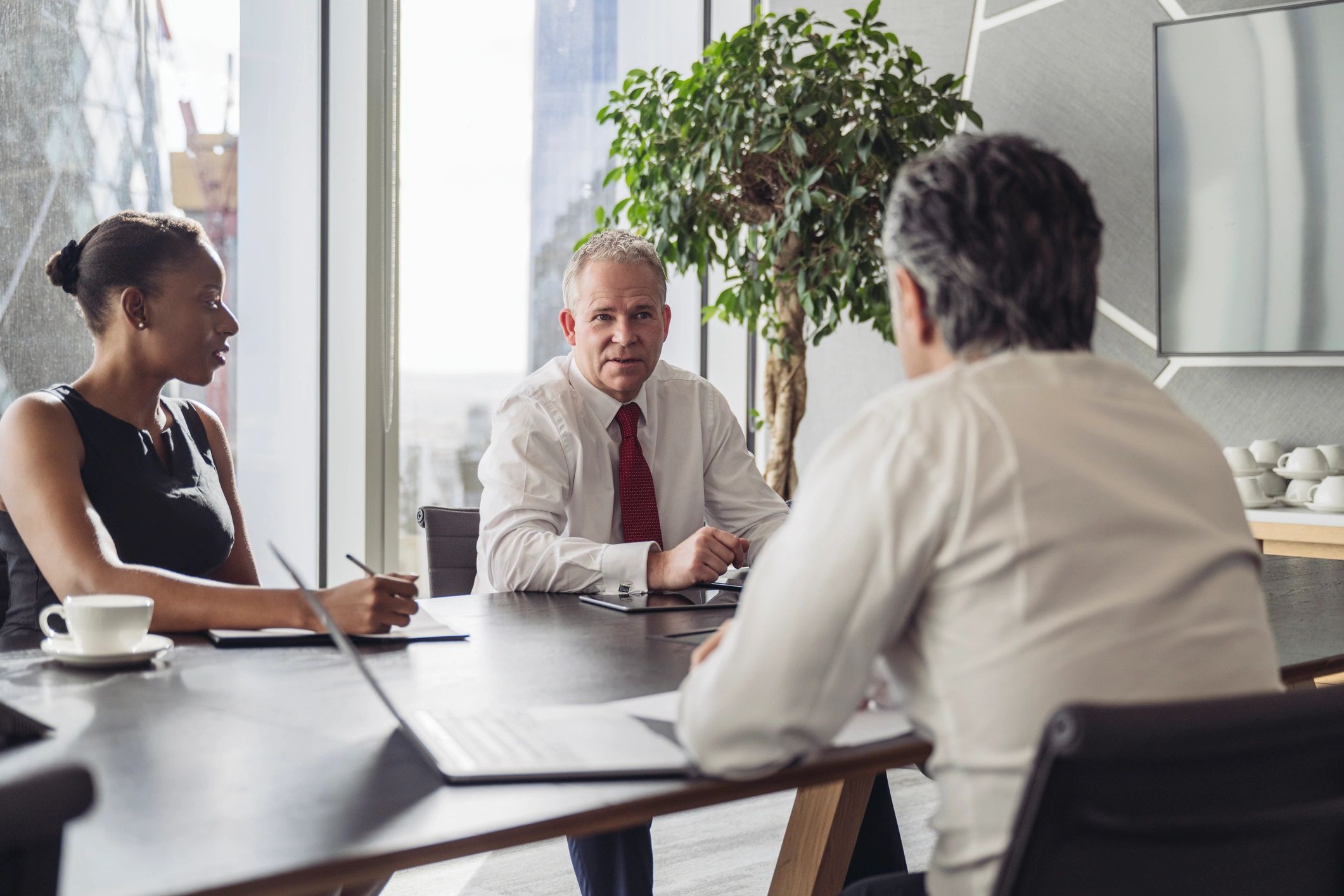 Corporate team conversing in modern board room