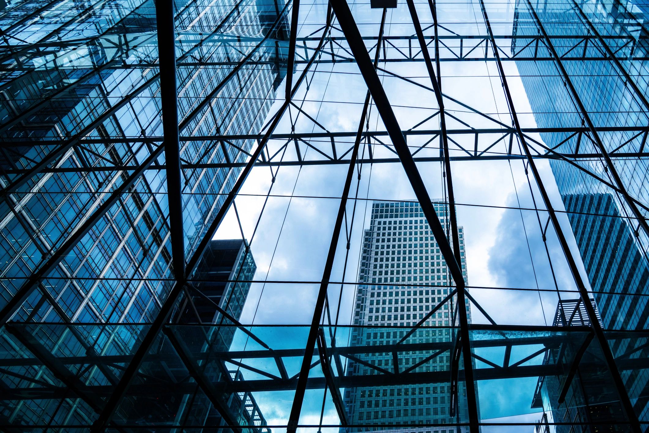 Modern Glass Building Skyline with Steel Framework and Blue Sky Reflections
